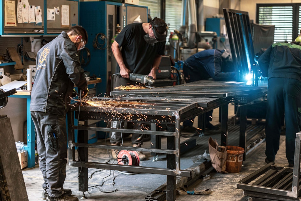 Sparks of transformation - every weld a step closer to realizing the seemingly impossible: turning a container into an extraordinary trade show booth.
