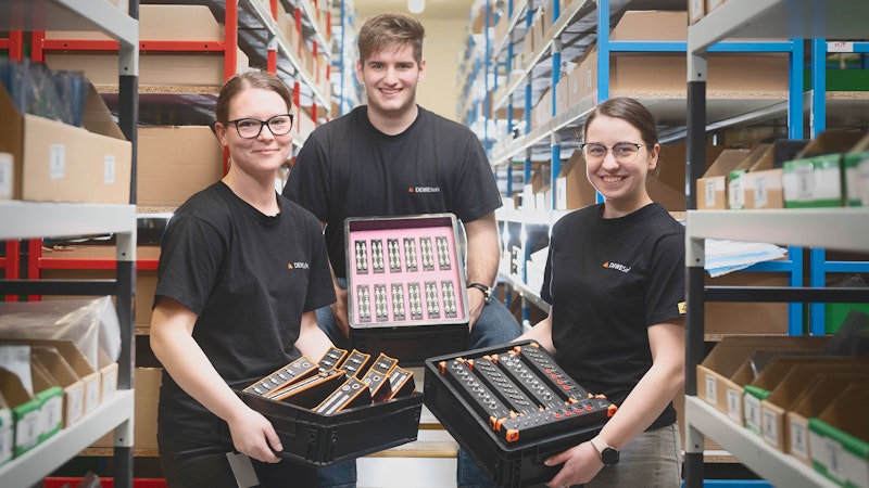 Dewesoft employees handling DAQ demo equipment