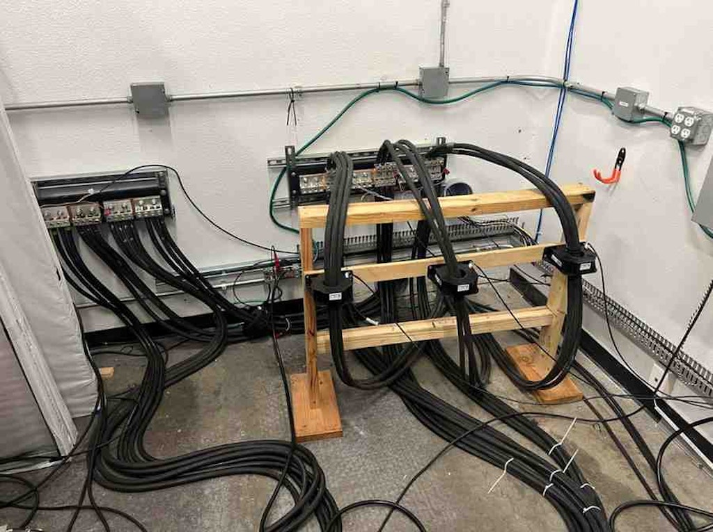 The test bed’s access and product junction point for current and voltage measurement. Notice the three current sensors mounted on the wooden insulator.