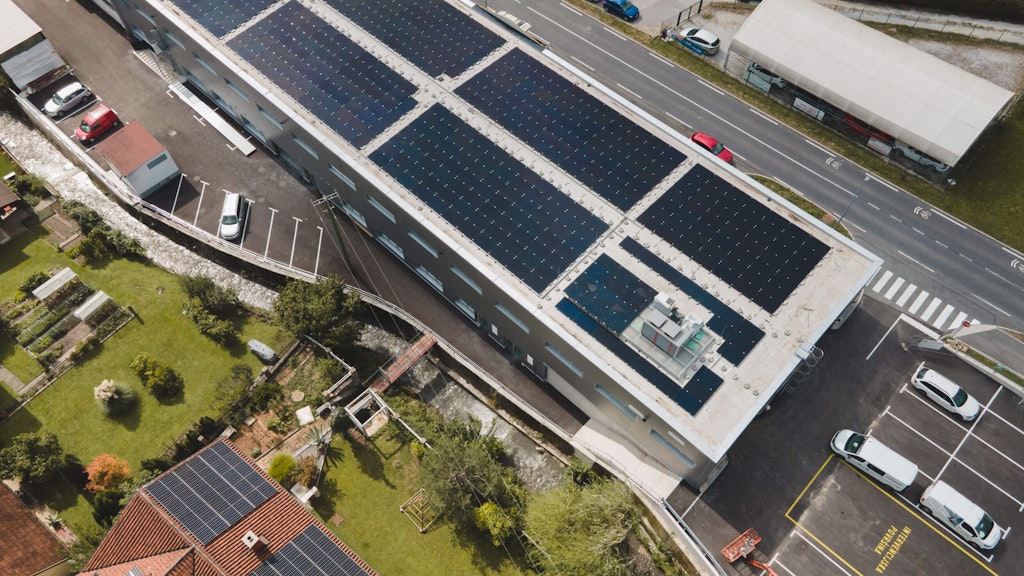Aerial view of the Dewesoft production facility with the solar panels. The BTES system is below the parking in the lower right corner of the photo.