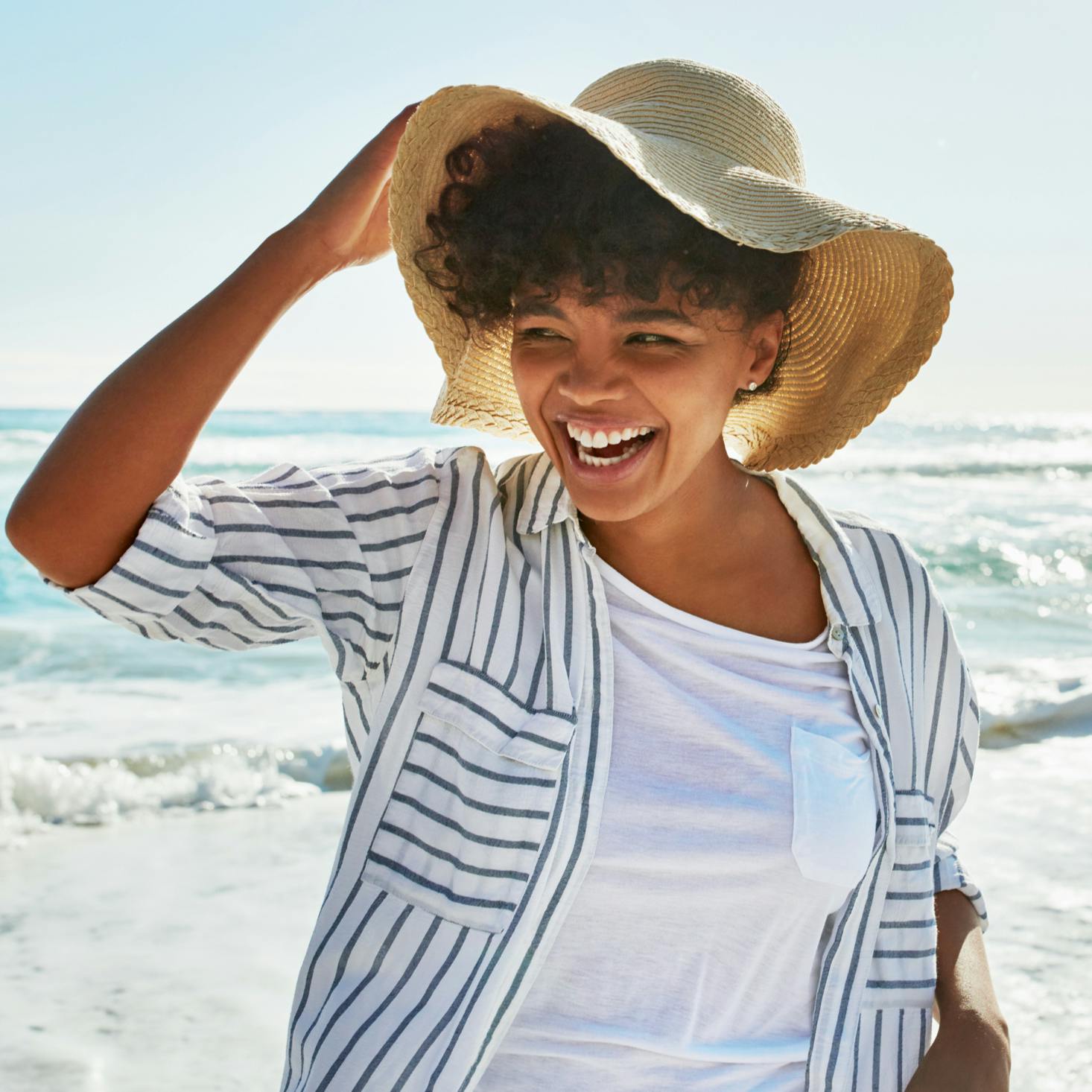Woman at the beach, smiling