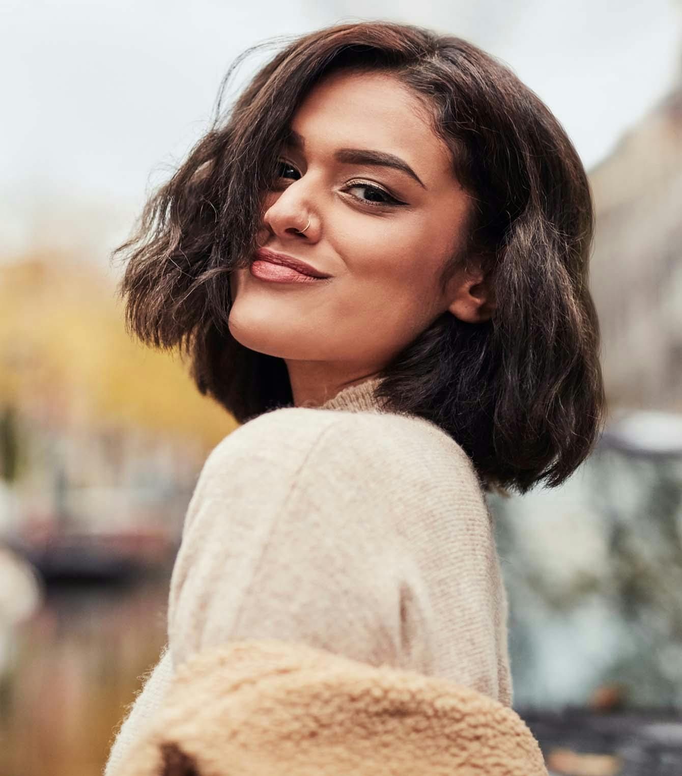 Beautiful girl with short brown hair smirking