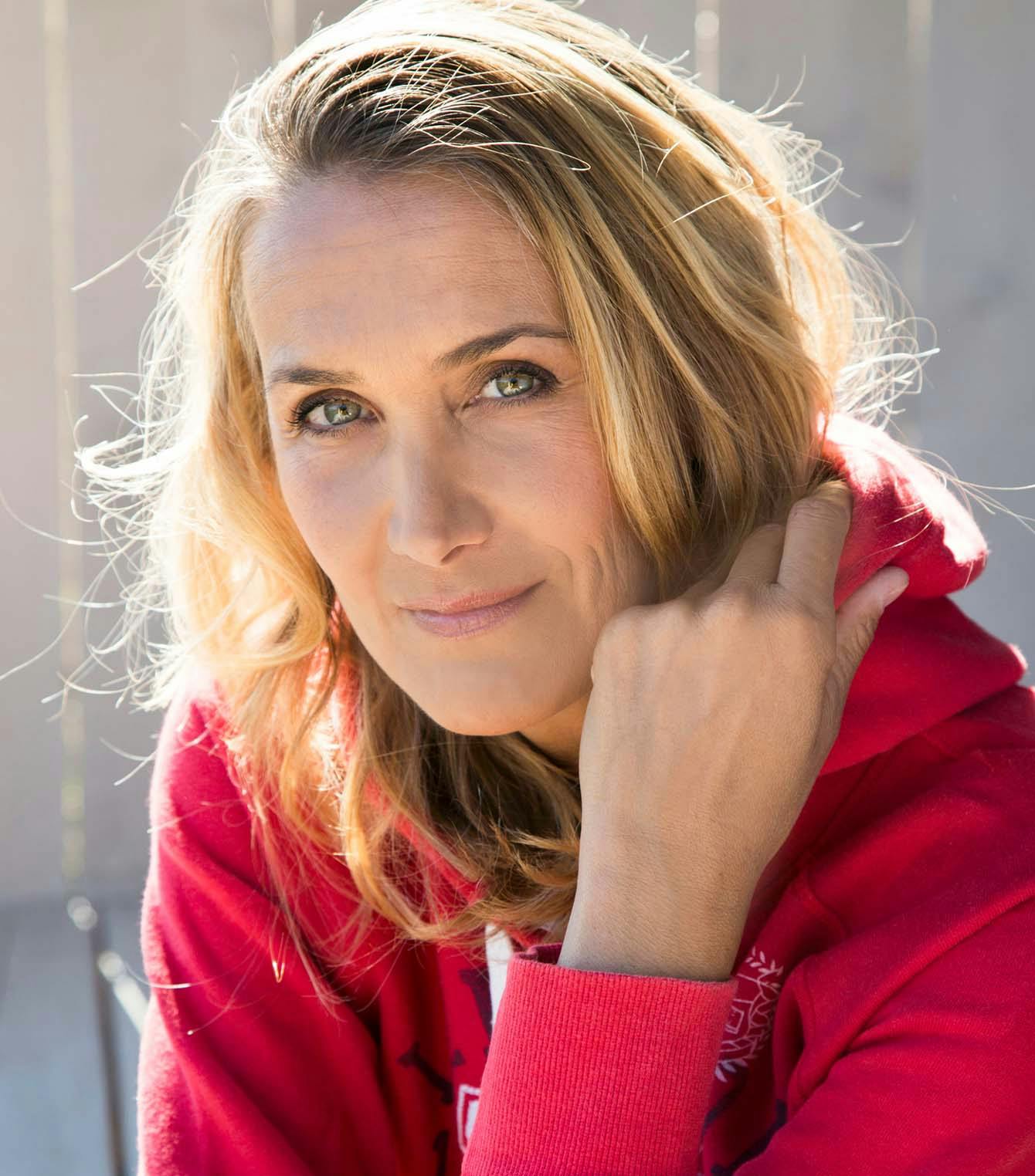 Blonde woman wearing a red hoodie
