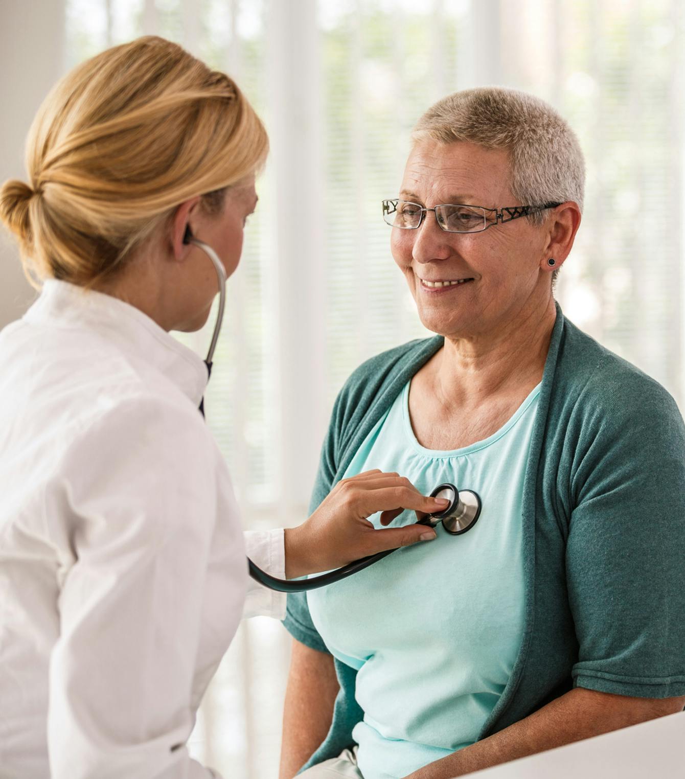 doctor with stethoscope on another person