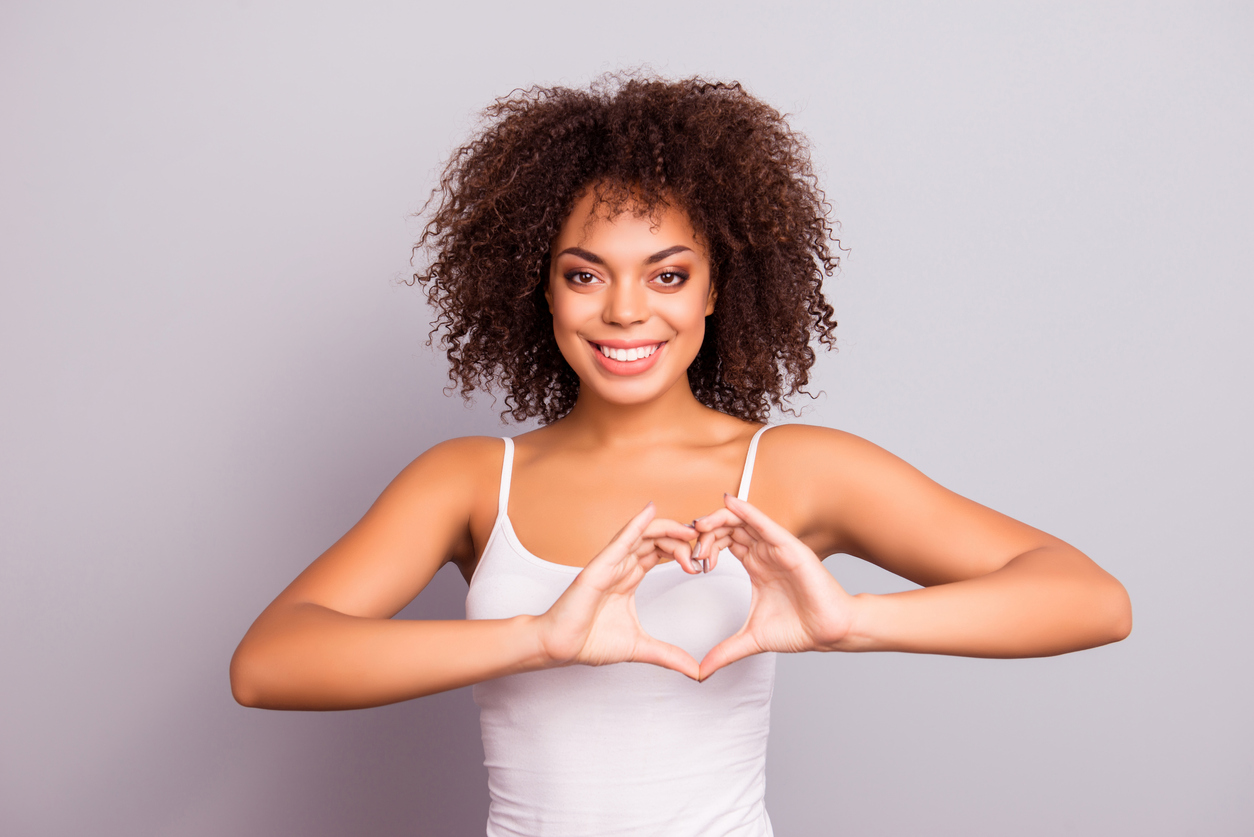 Woman Holding Her Hands in the Shape of a Heart