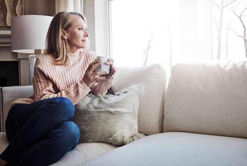 Woman Drinking Coffee on Her Couch