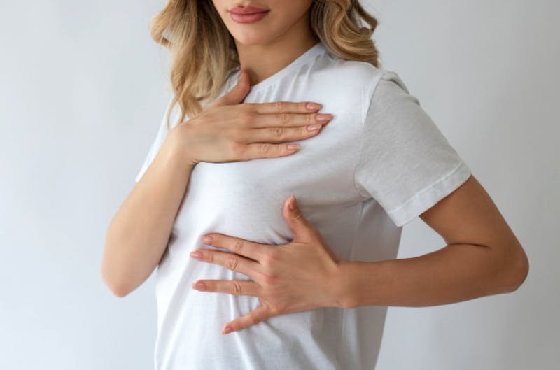 Woman examining her breast