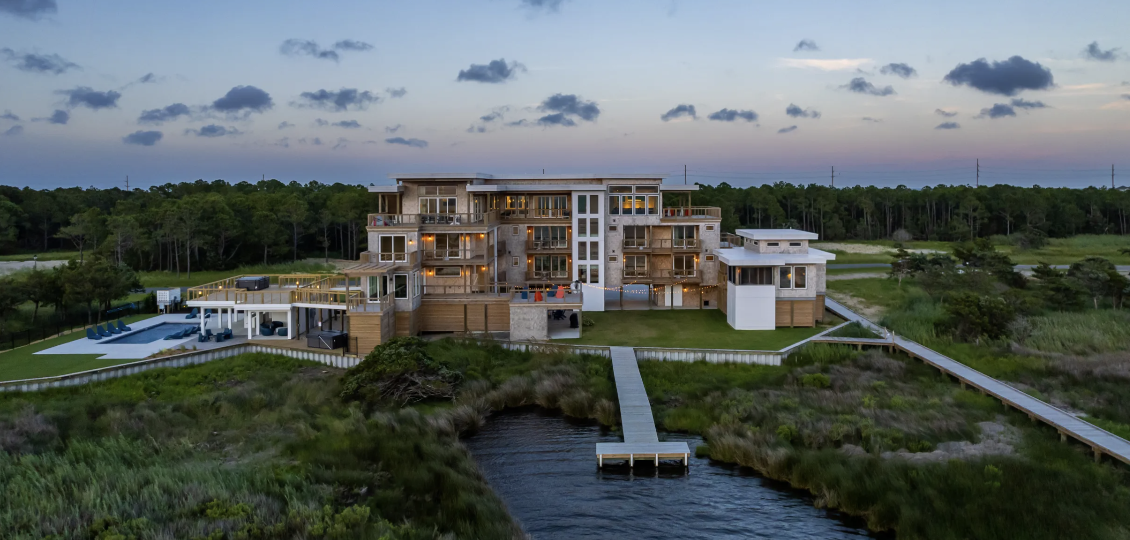 Wander's Salvo Glow property in North Carolina. The images shows the large scale of the property, with the outdoor pool to the left and its own private harbour