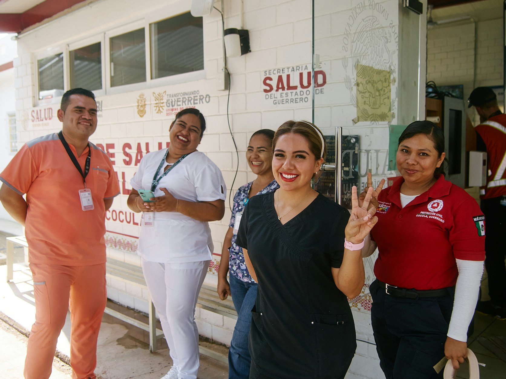 A group of healthcare professionals standing outside a clinic.