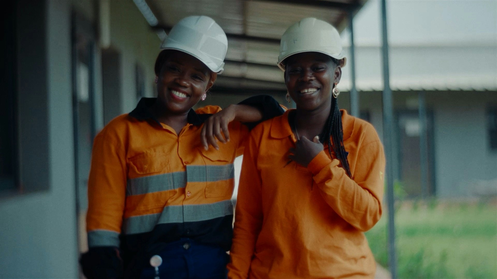 Two mine workers smiling at the camera