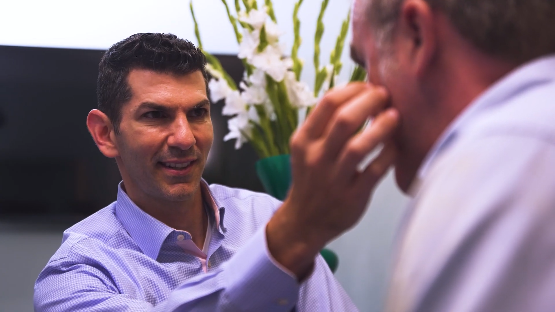 Dr. Cappuccino giving a patient a facial consultation