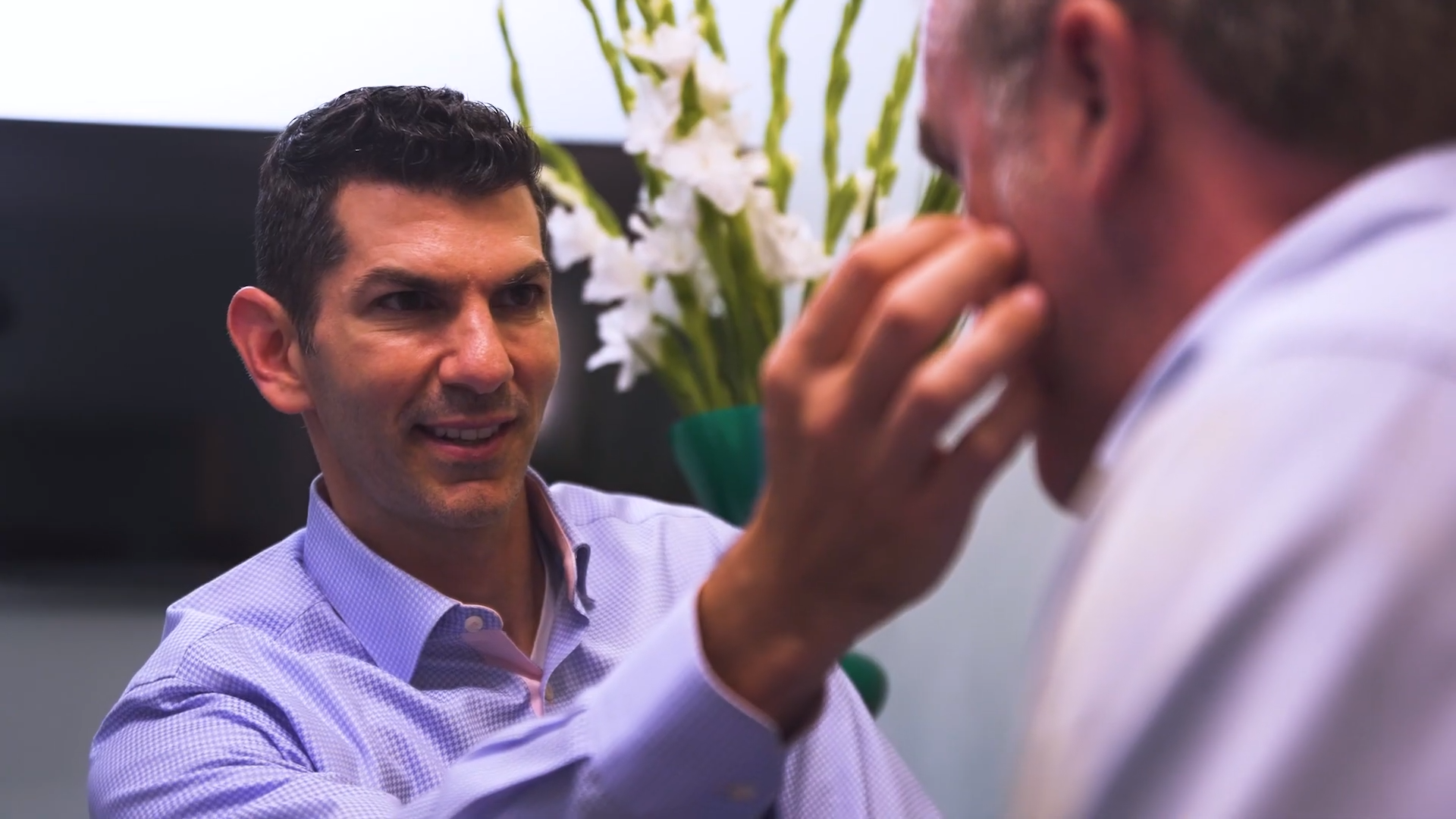 Dr. Cappuccino doing a facial consultation on a male patient