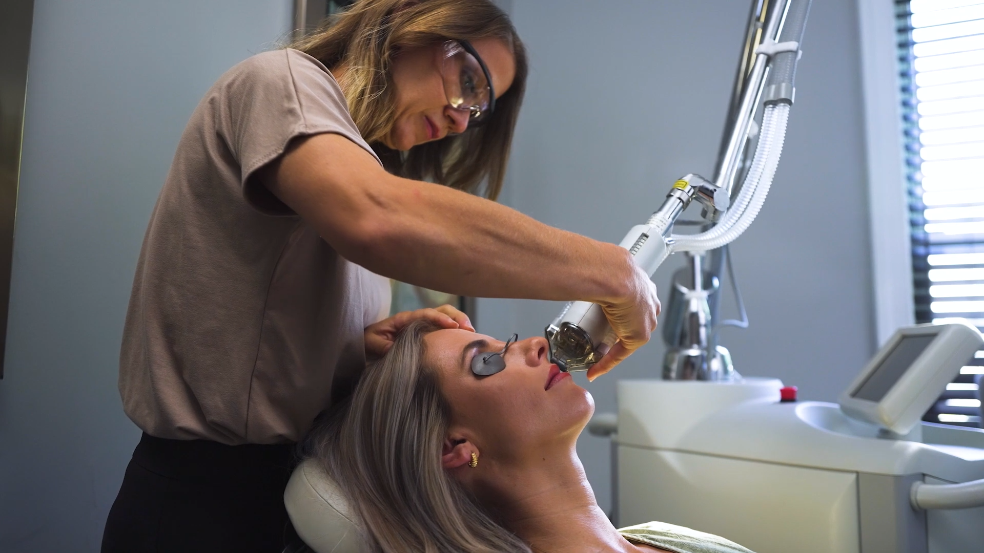Dr. Cappuccino performing one of her laser treatments on a blonde patient