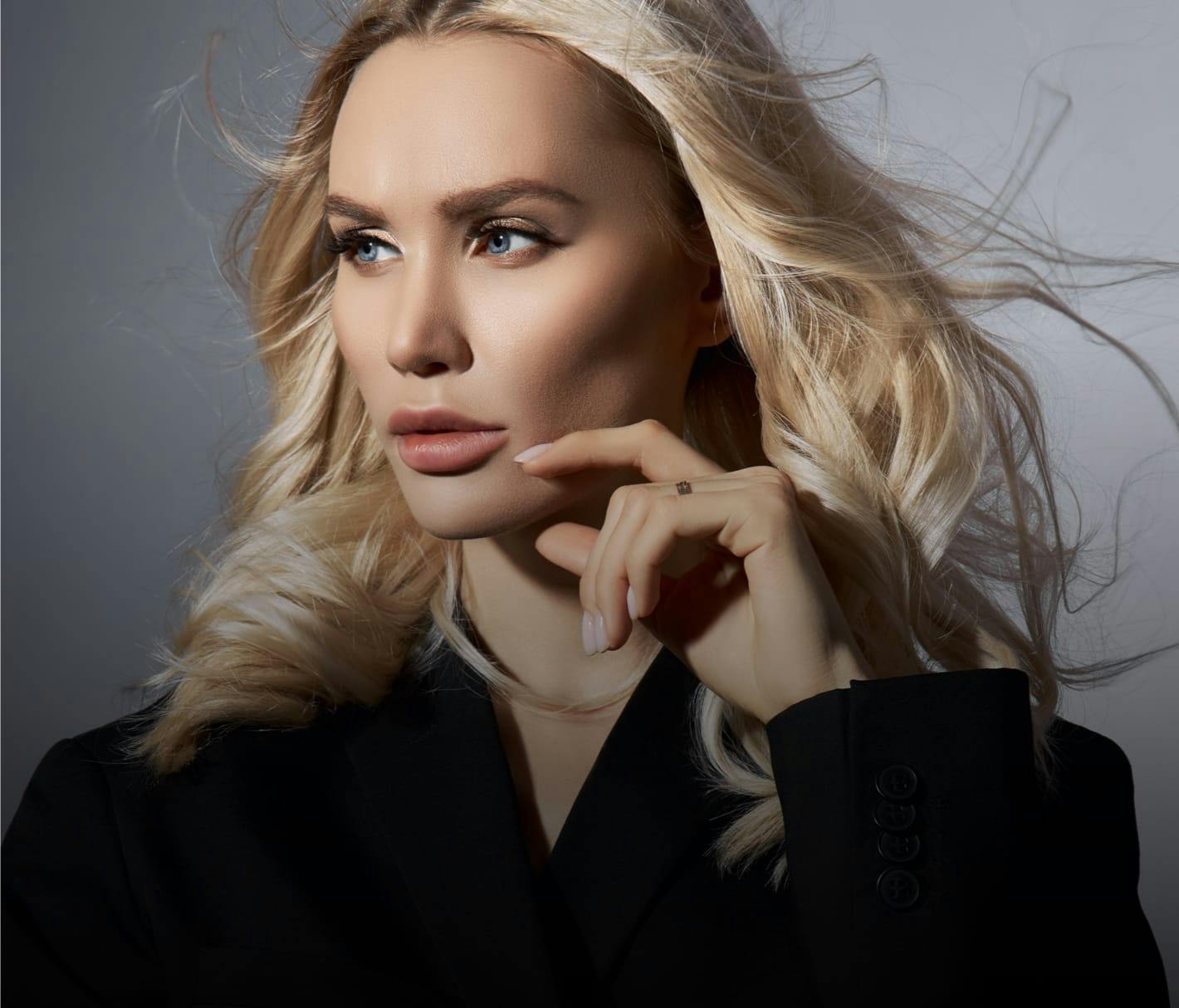 Blonde woman with smooth skin looking off camera