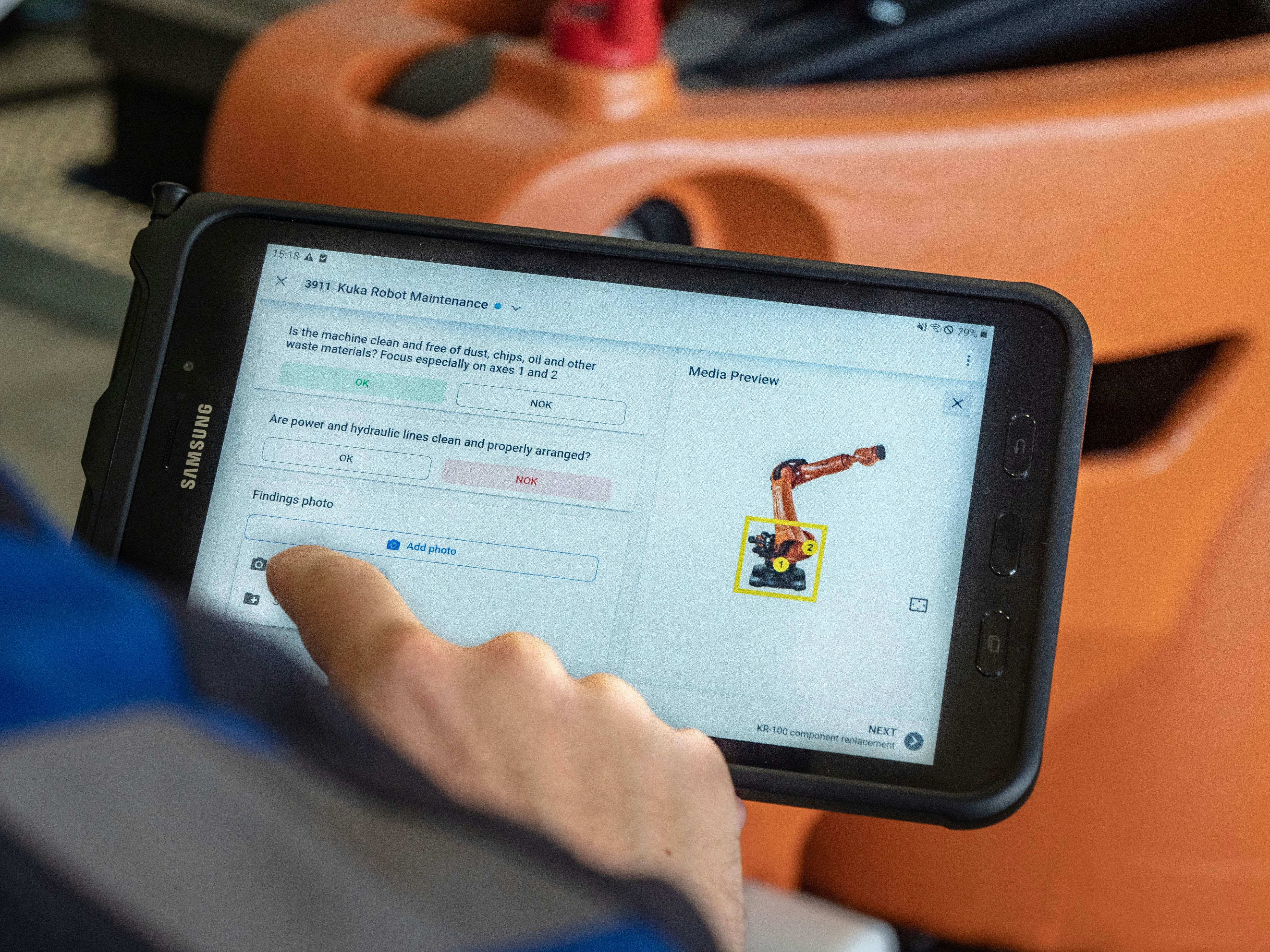 Worker uses the operations1 software to be guided through a kuka robot maintenance job