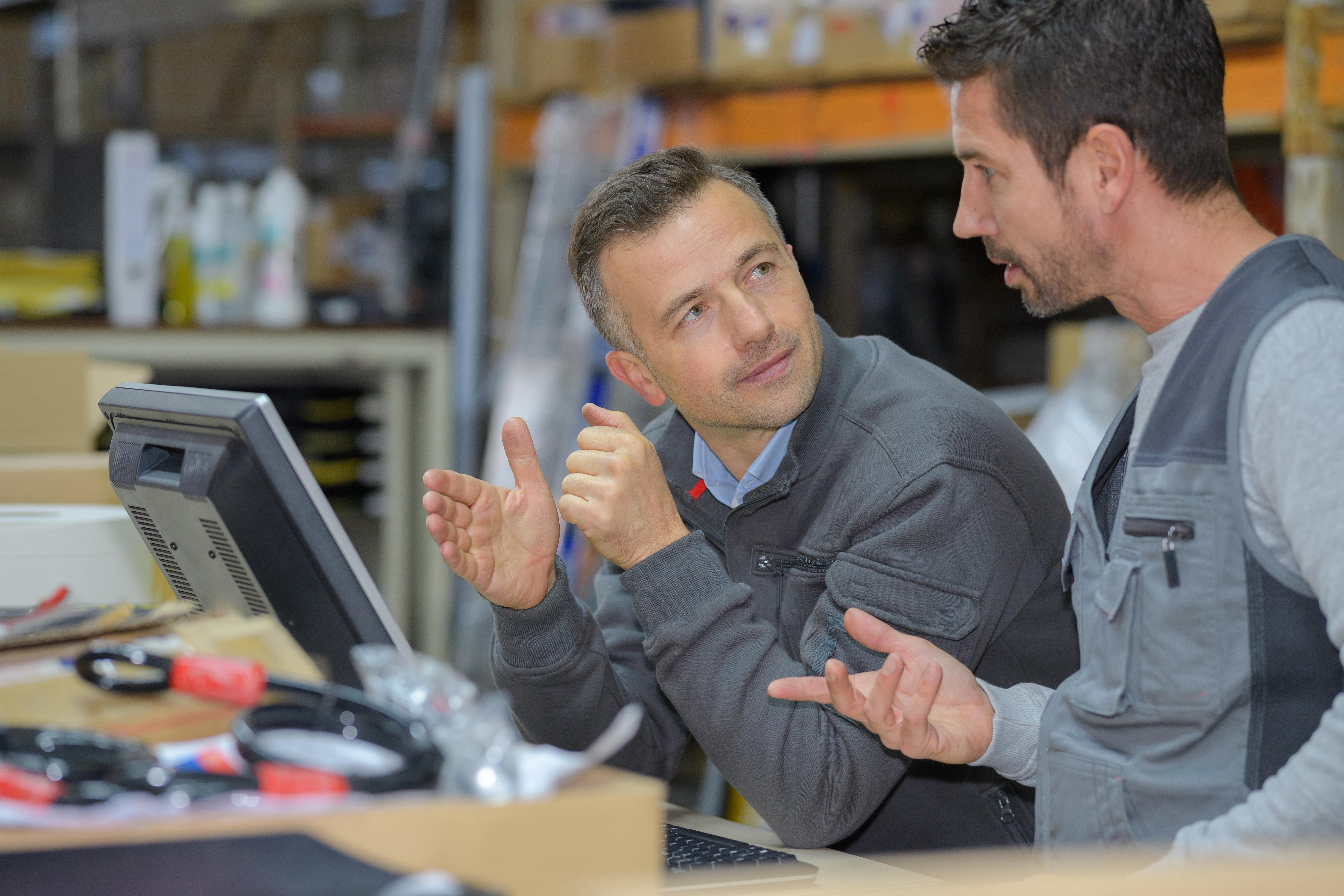 Employees discuss a finding in the manufacturing process