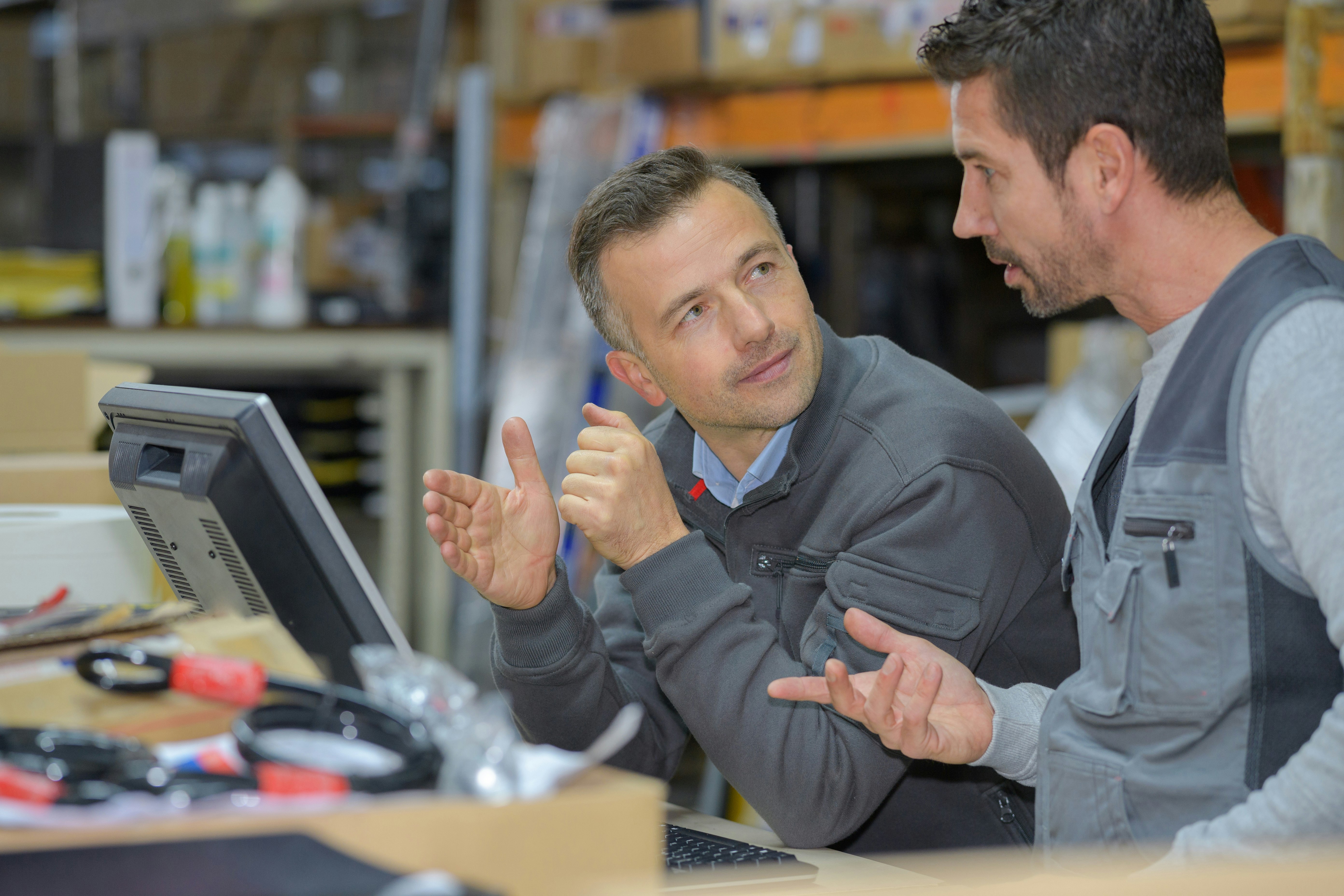 Employees discuss a finding in the manufacturing process