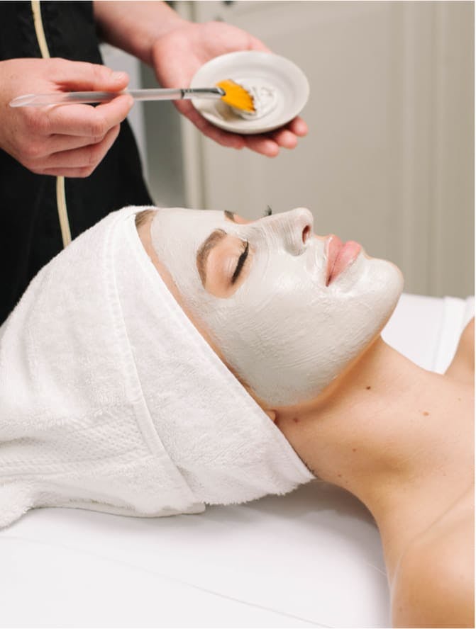 Woman eyes closed with head towel and face mask on
