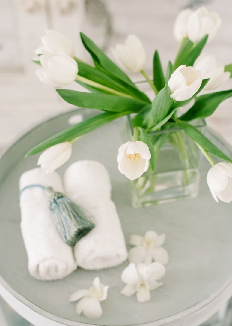 white flowers on tray with towels