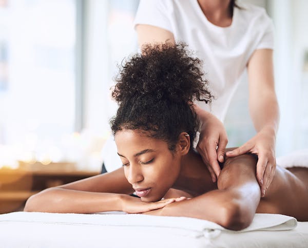 young woman getting a shoulder massage