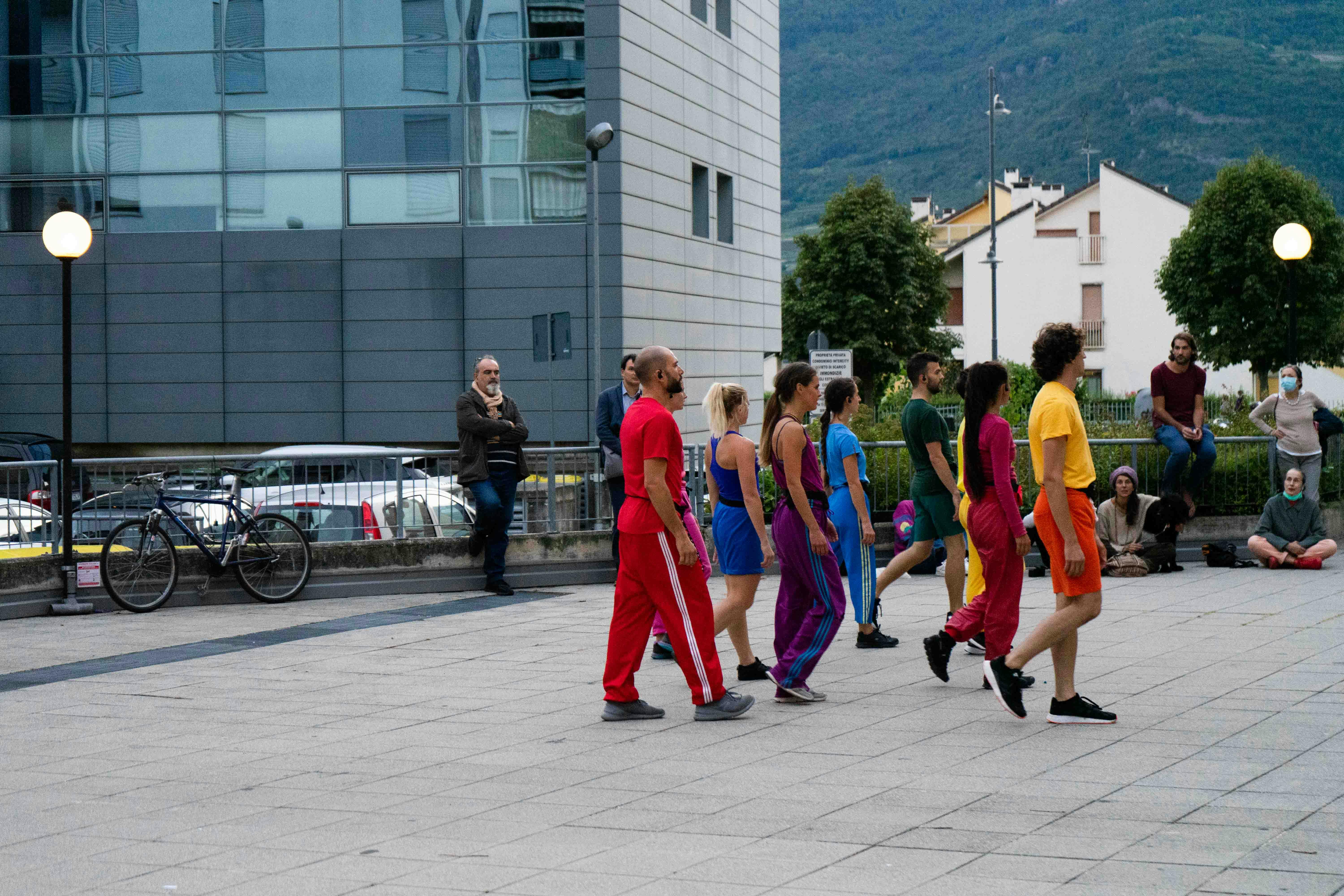 During open rehearsals, in the square, the dancers are grouped together in one spot, posing.