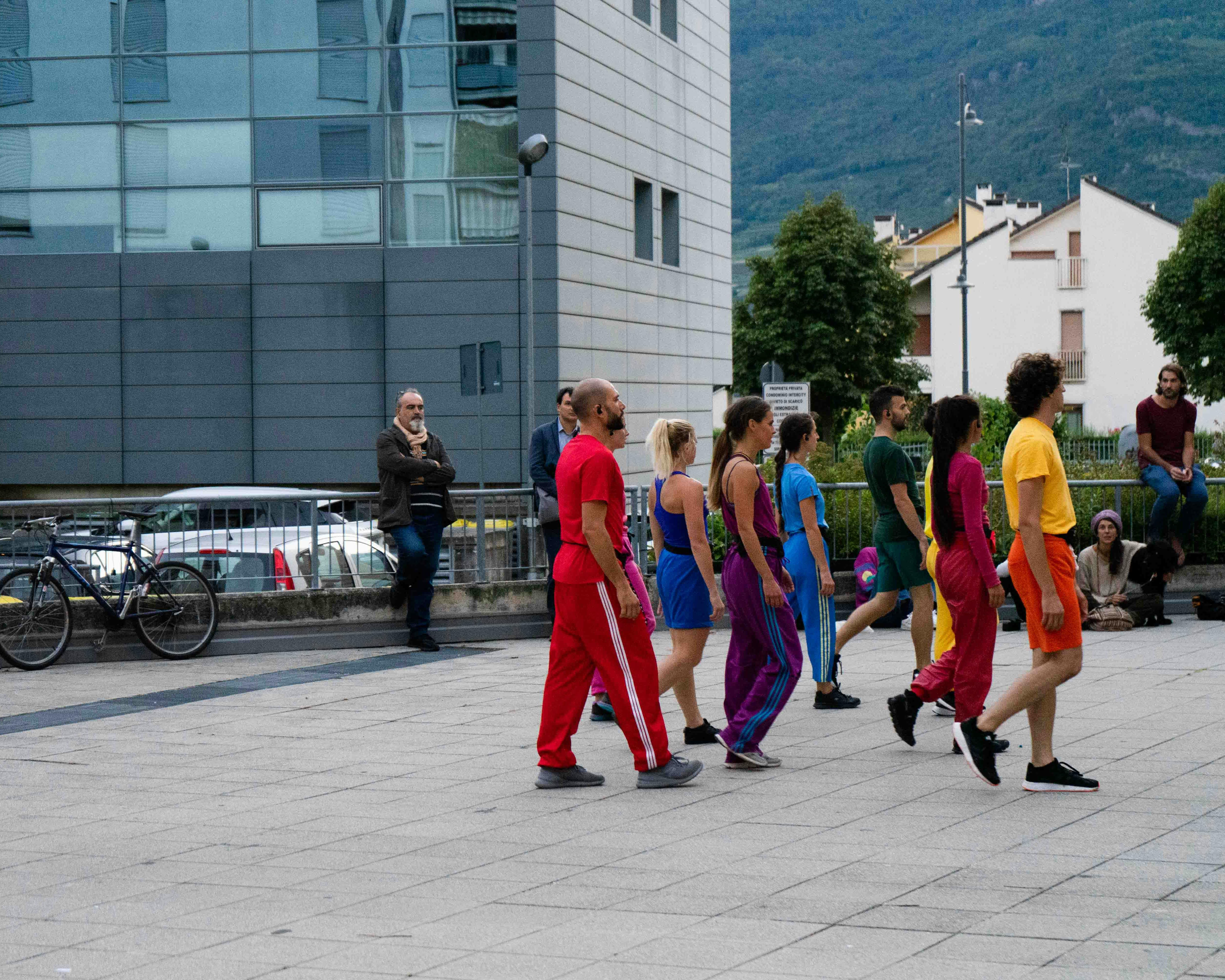 During open rehearsals, in the square, the dancers are grouped together in one spot, posing.