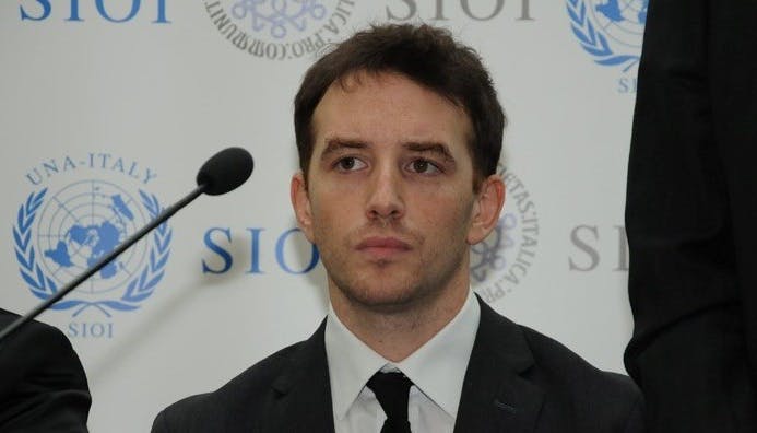 Half-length photo of Giorgio Cuscito during a conference.