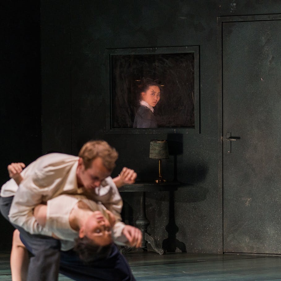 A man and a woman are dancing, she is falling with her head thrown back while he supports her by bending over her.