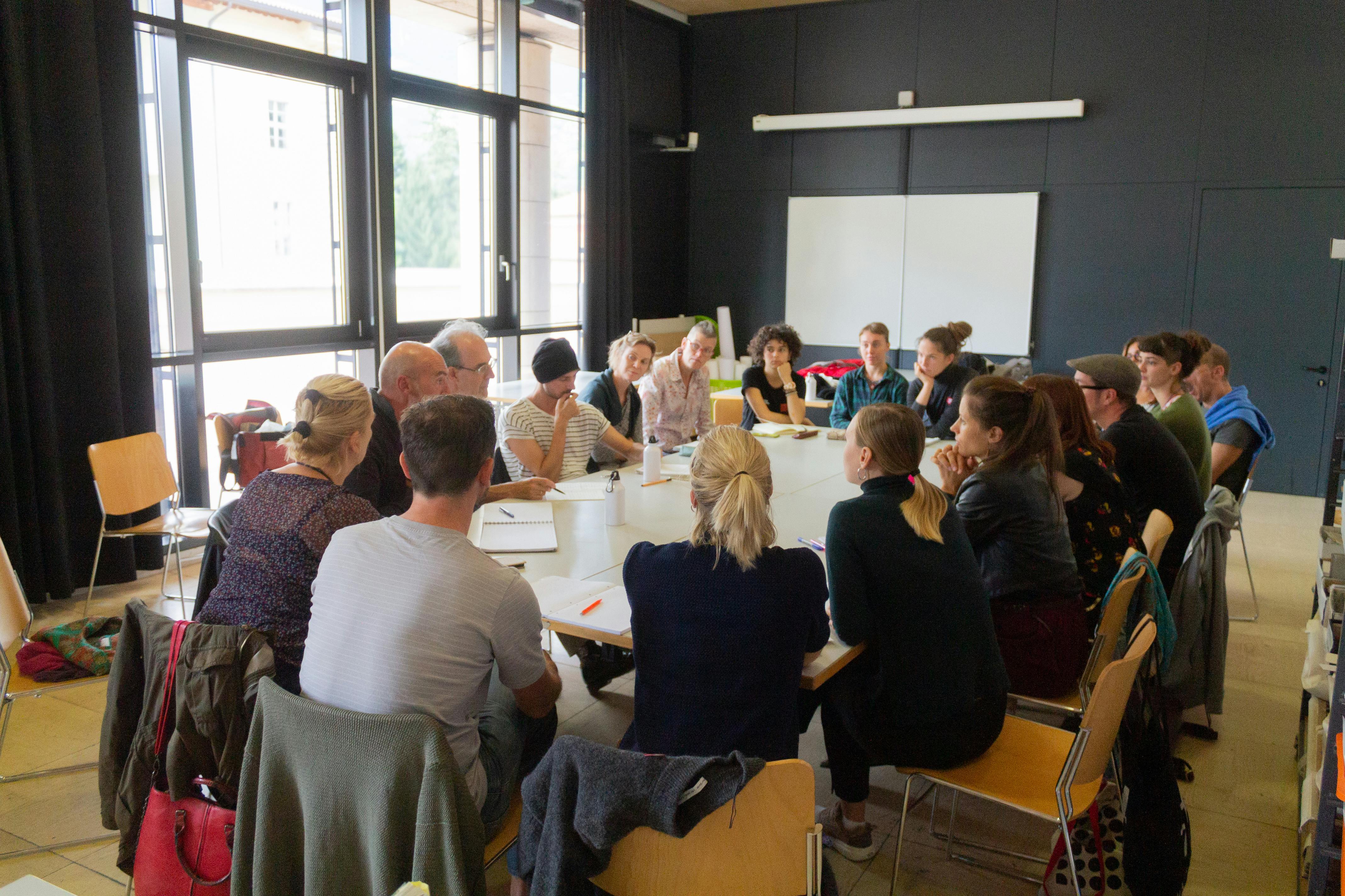 Cultural professionals with and without disabilities around a working table.