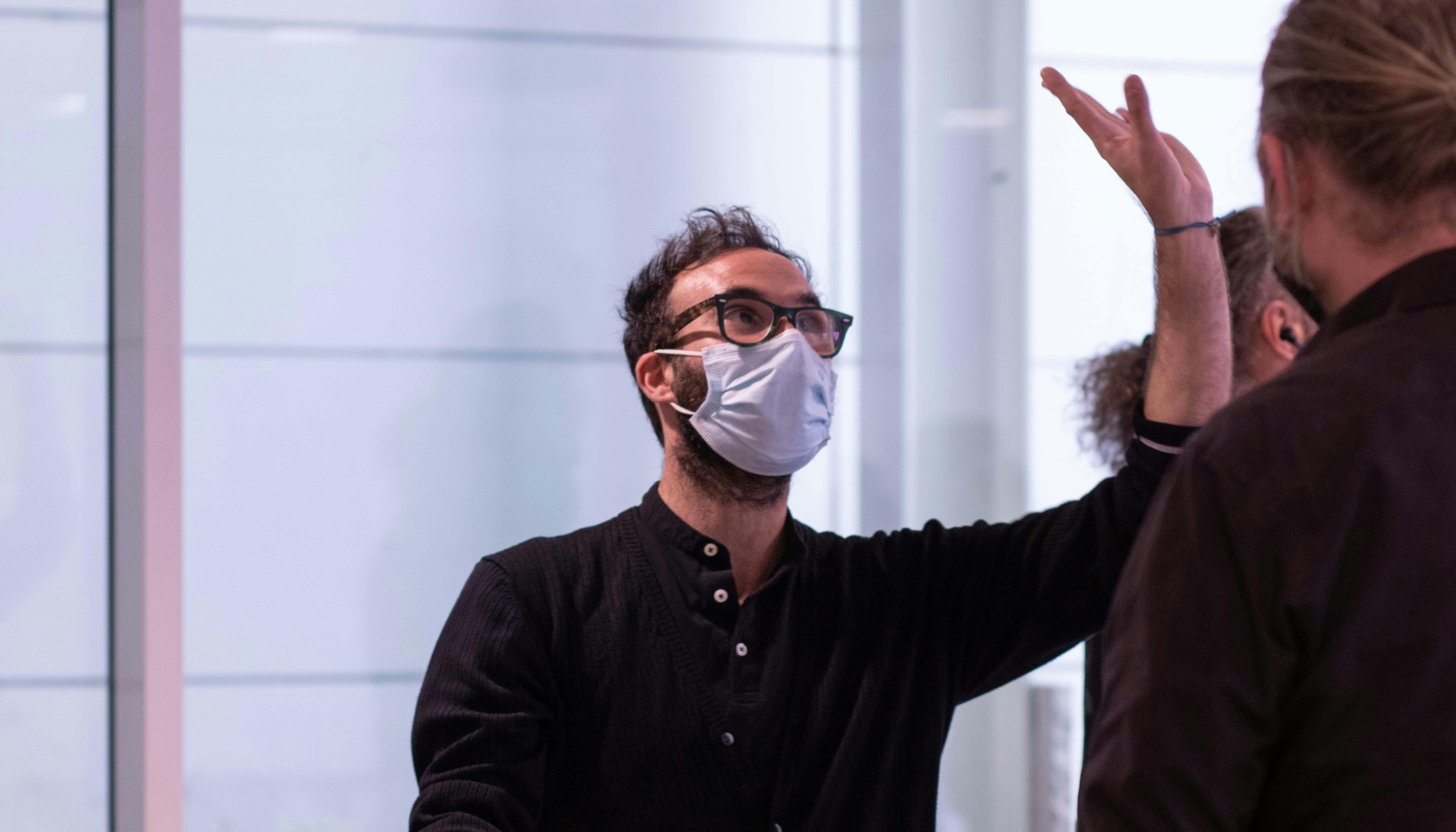 L'artista Aristide Rontini, partecipante al lab, mentre solleva il braccio sinistro verso l'alto con la mano aperta.