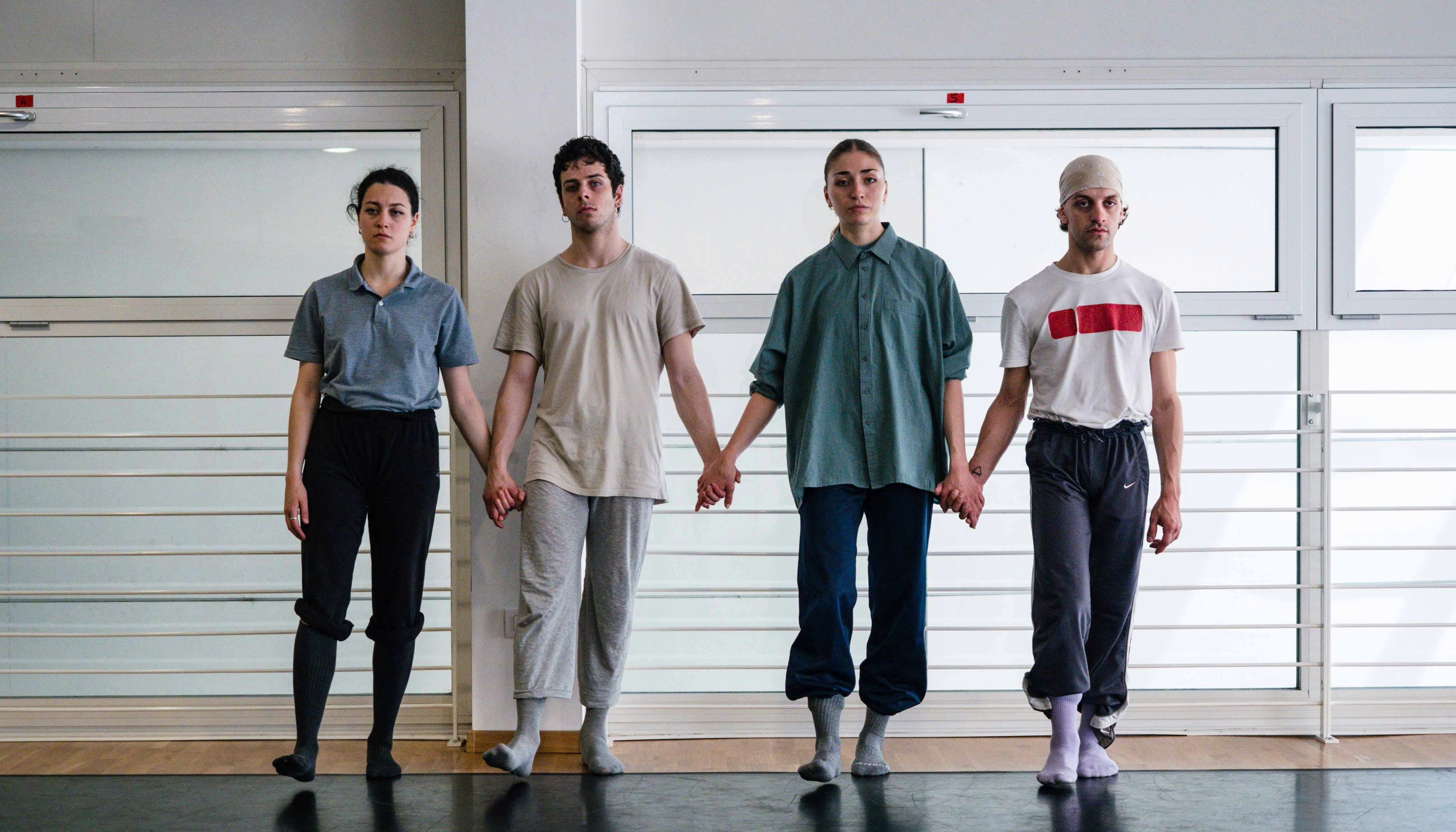 The four performers chosen by Tedesco hold hands walking forward