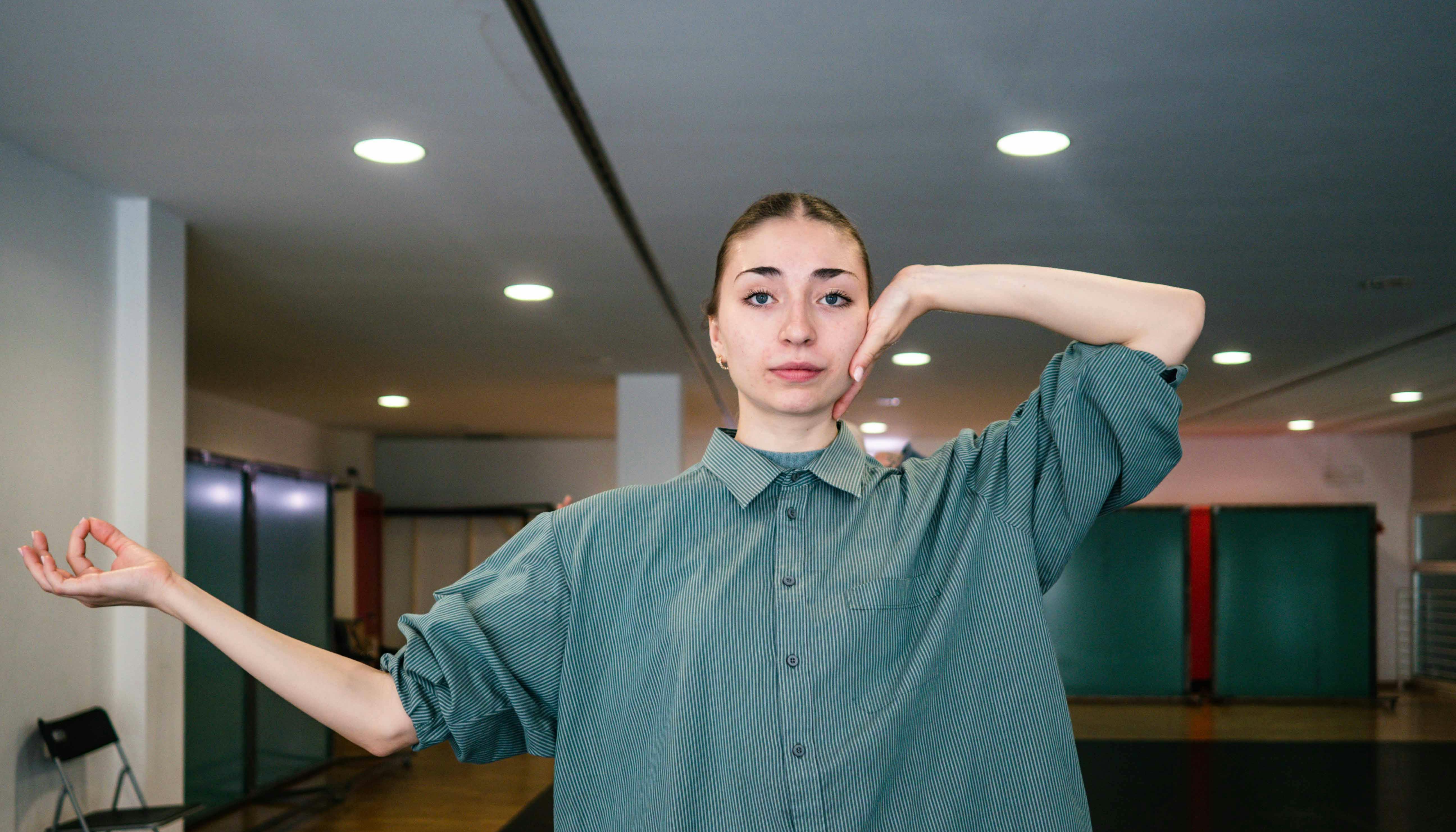 Performer in grey shirt posing