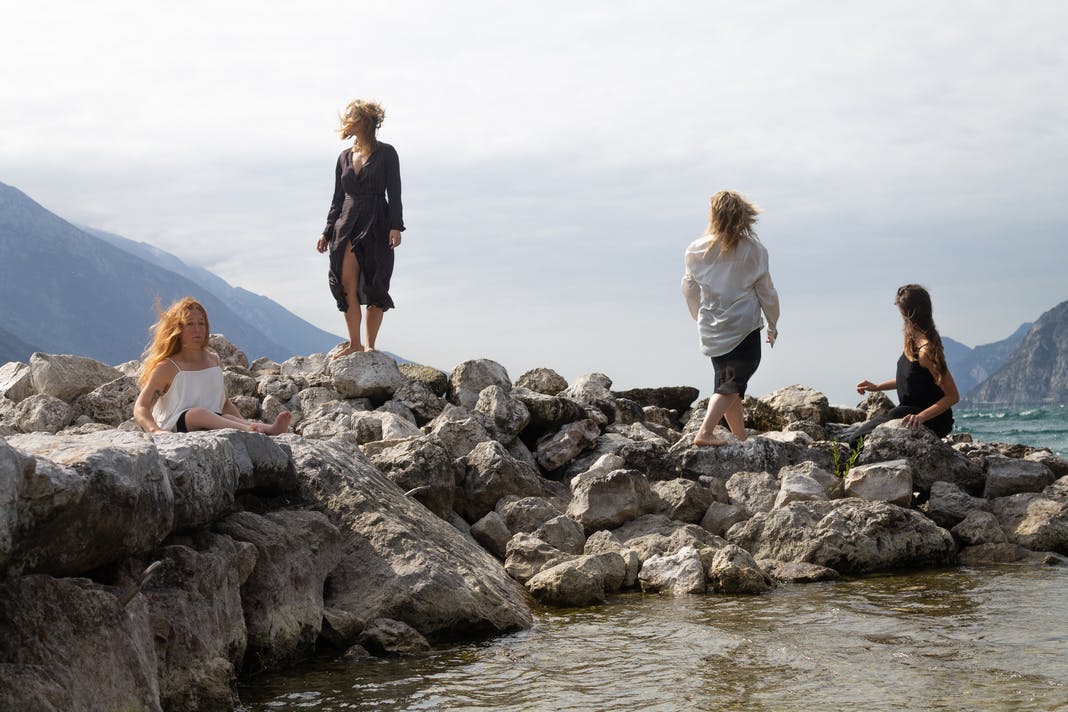 Four dancers positioned on the rocks