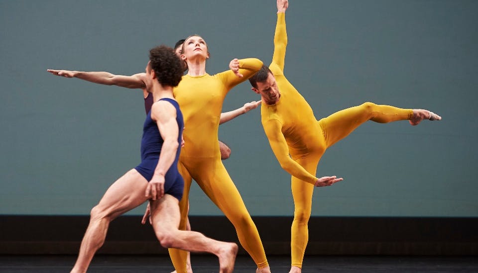 Four dancers perform onstage