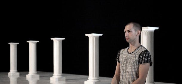 The dancer in the foreground with Greek columns behind him
