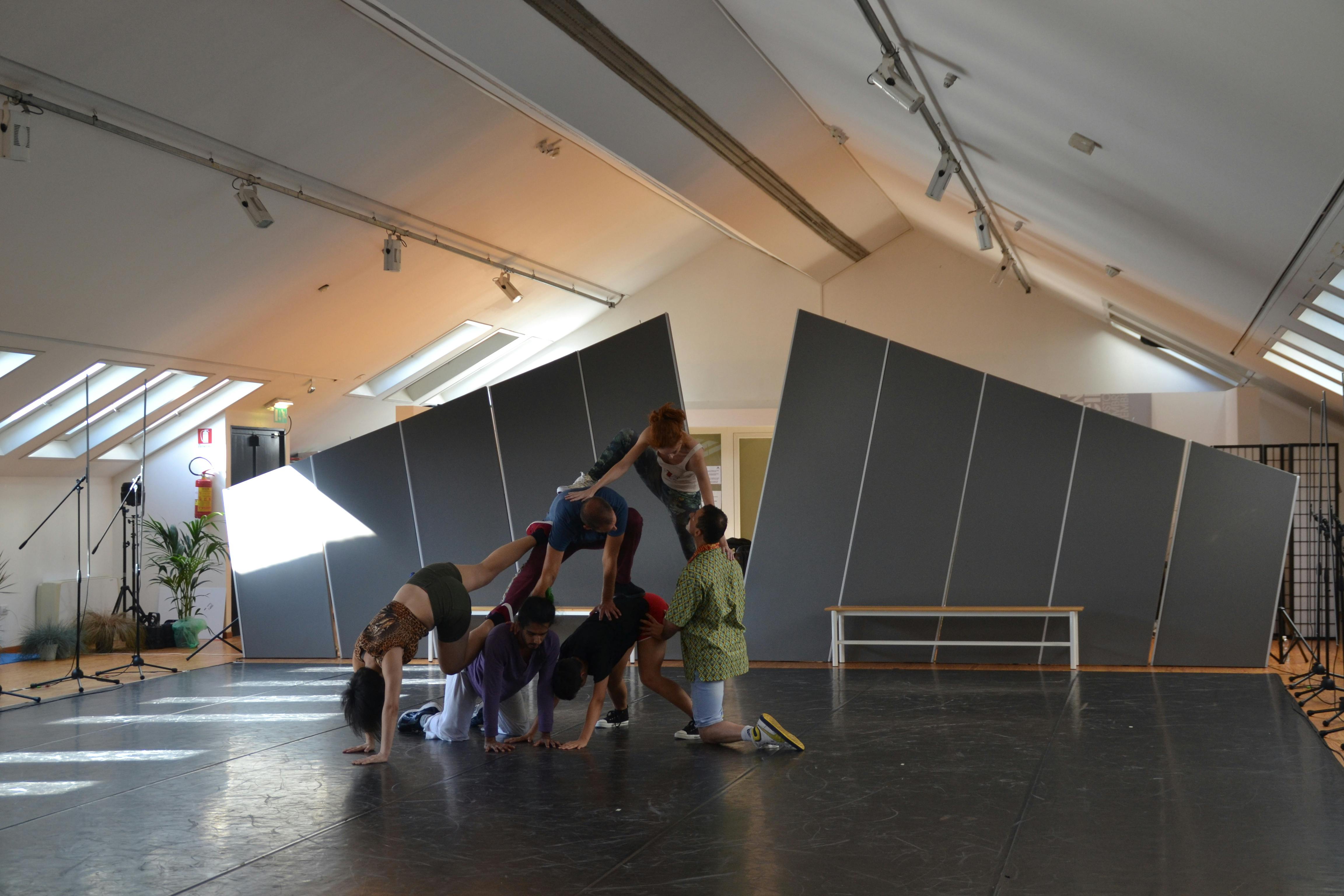 Dancers try a pyramid pose