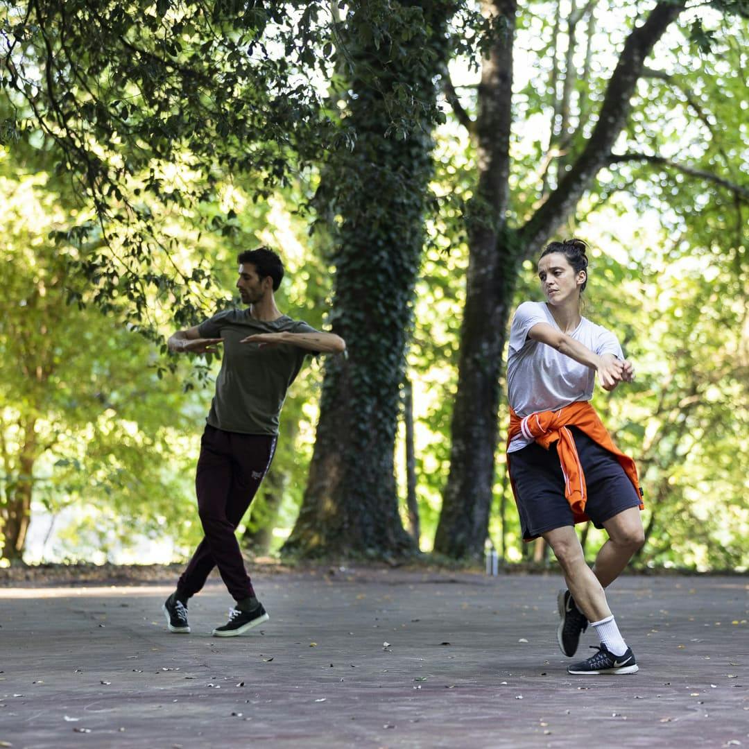 Two dancers perform in nature