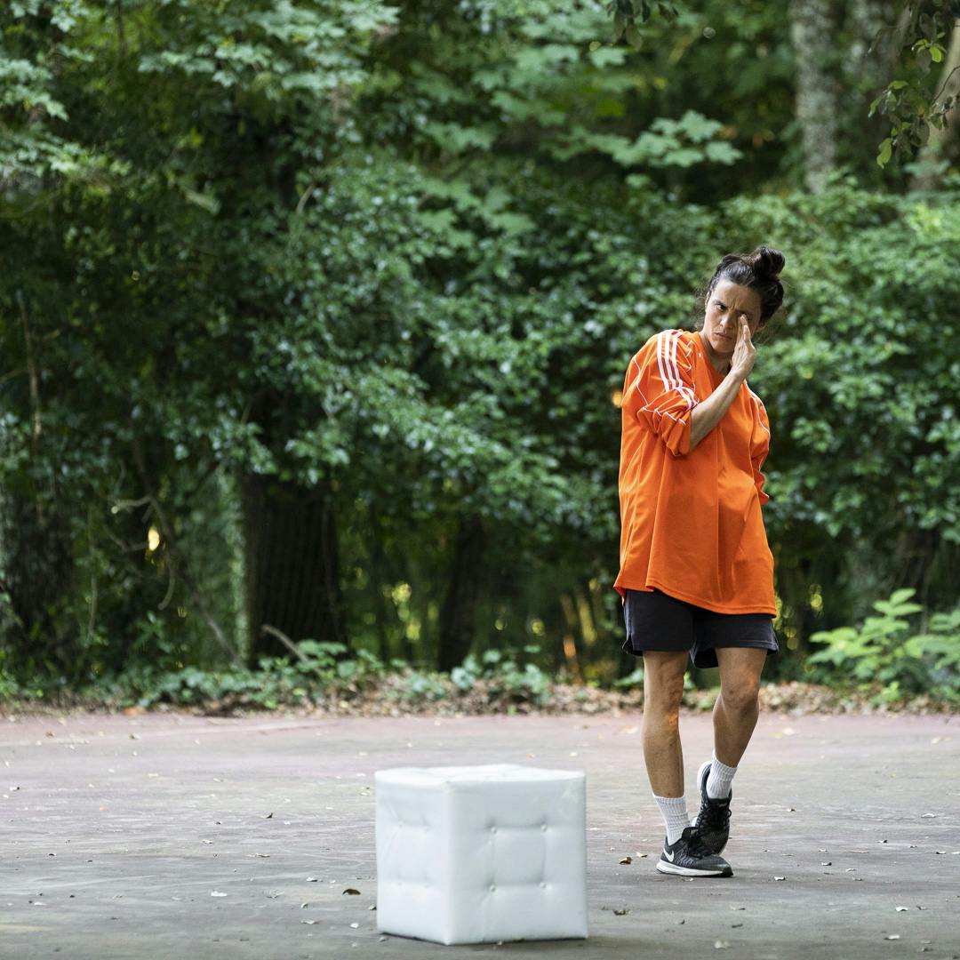 Dancer approaches dancing to white cube