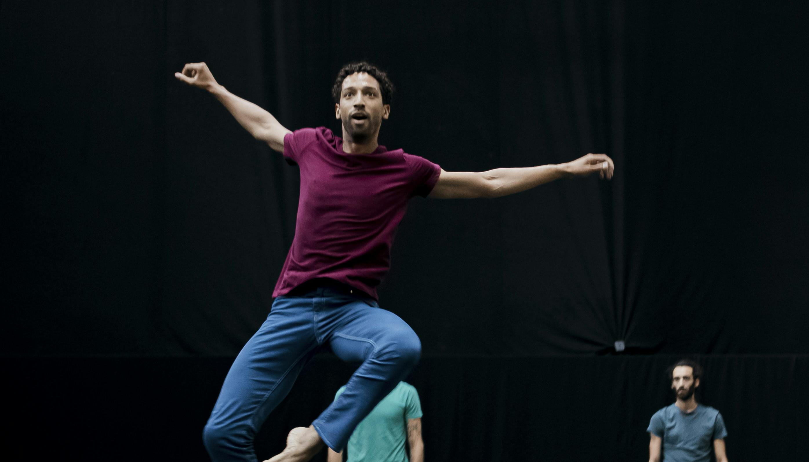 Philippe Kratz performs a jump wearing a burgundy jersey and blue trousers
