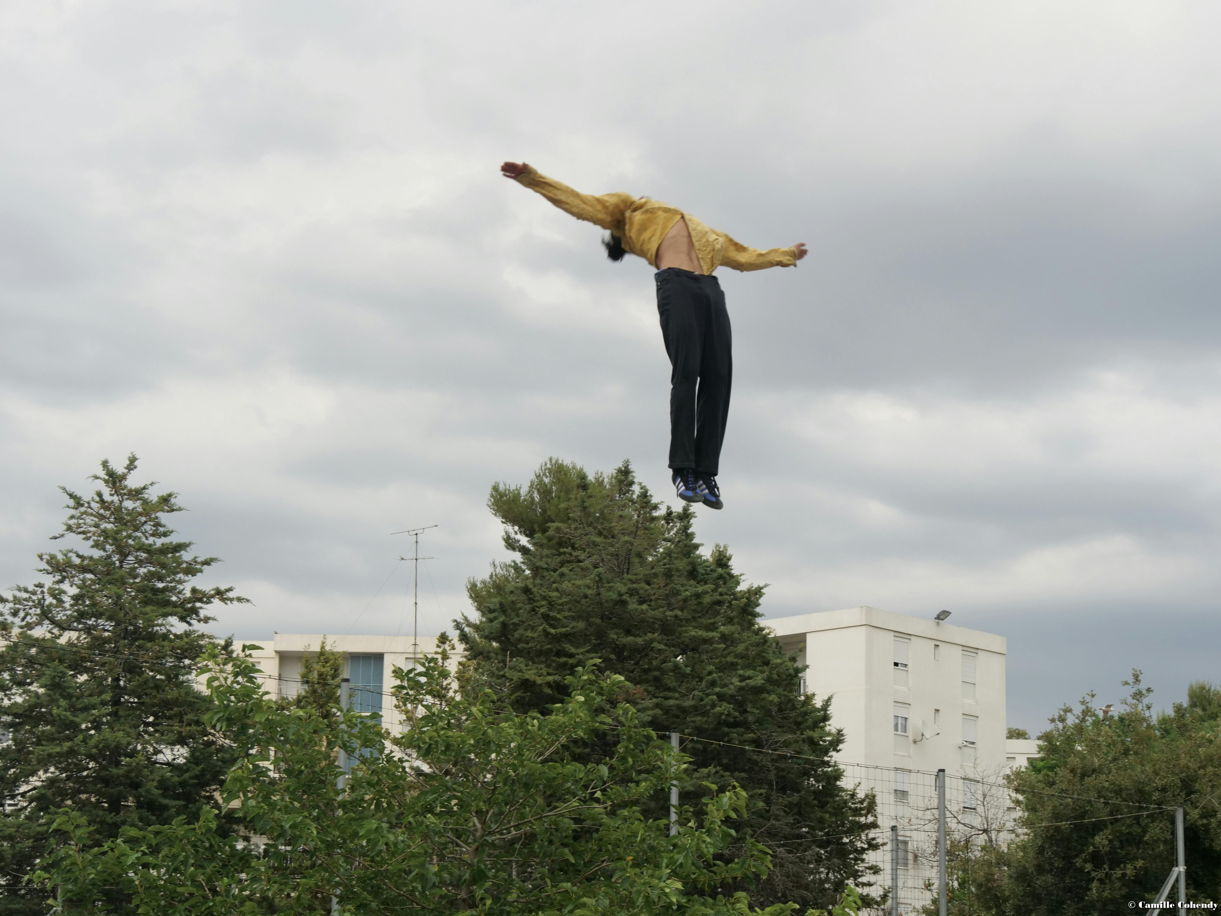 A dancer from the Colokolo company performs a jump 