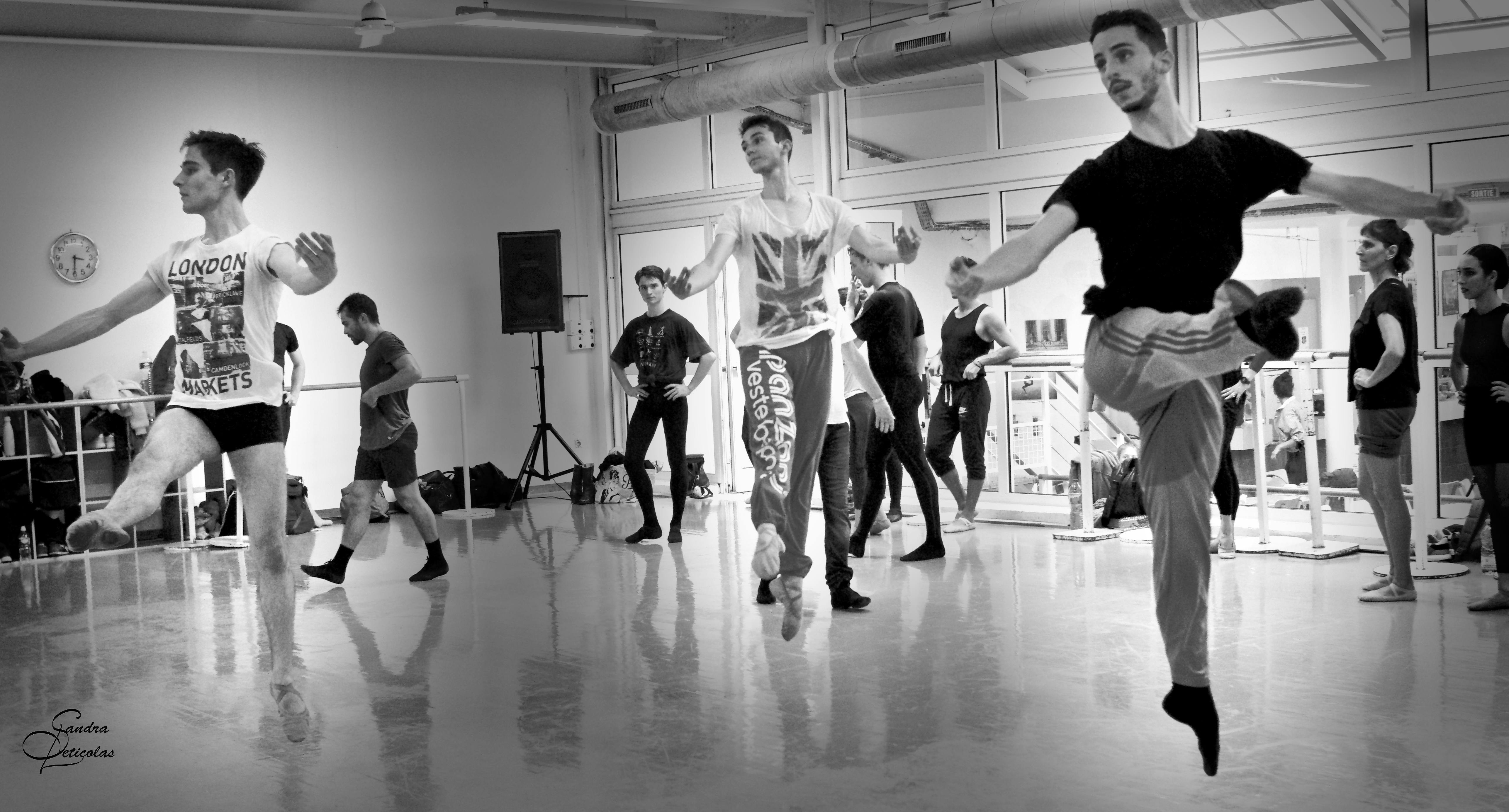 A black and white photo of Wayne Byars students performing a jump in class
