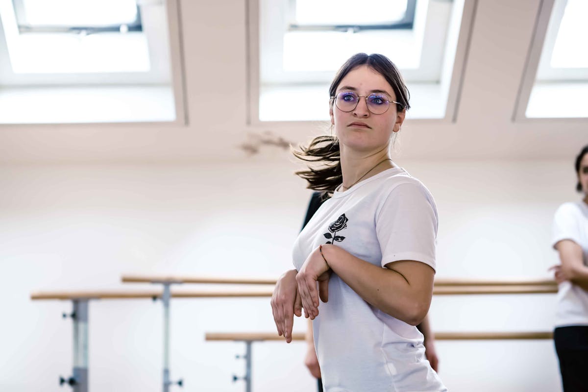 Girl in hall during Creature Selvagge workshop imitates a groundhog