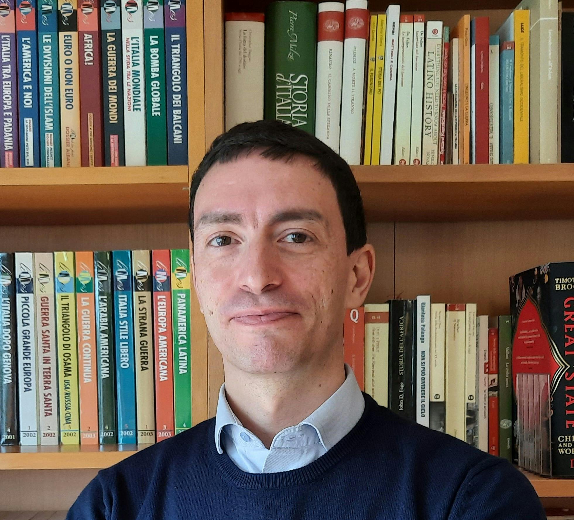 Close-up of Fabrizio Maronta, with a bookcase in the background