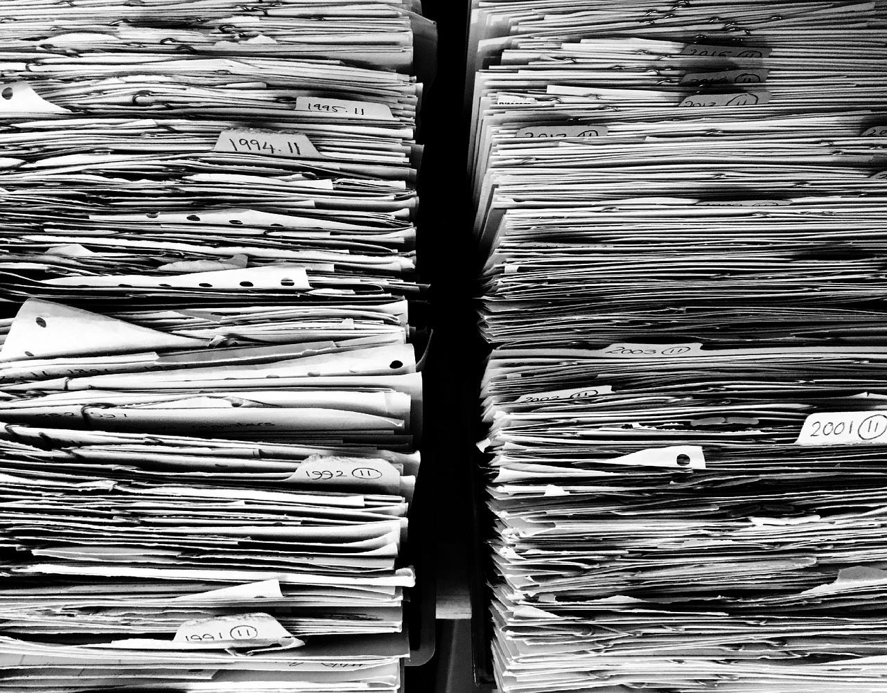 Fotografia in bianco e nero di due pile di documenti