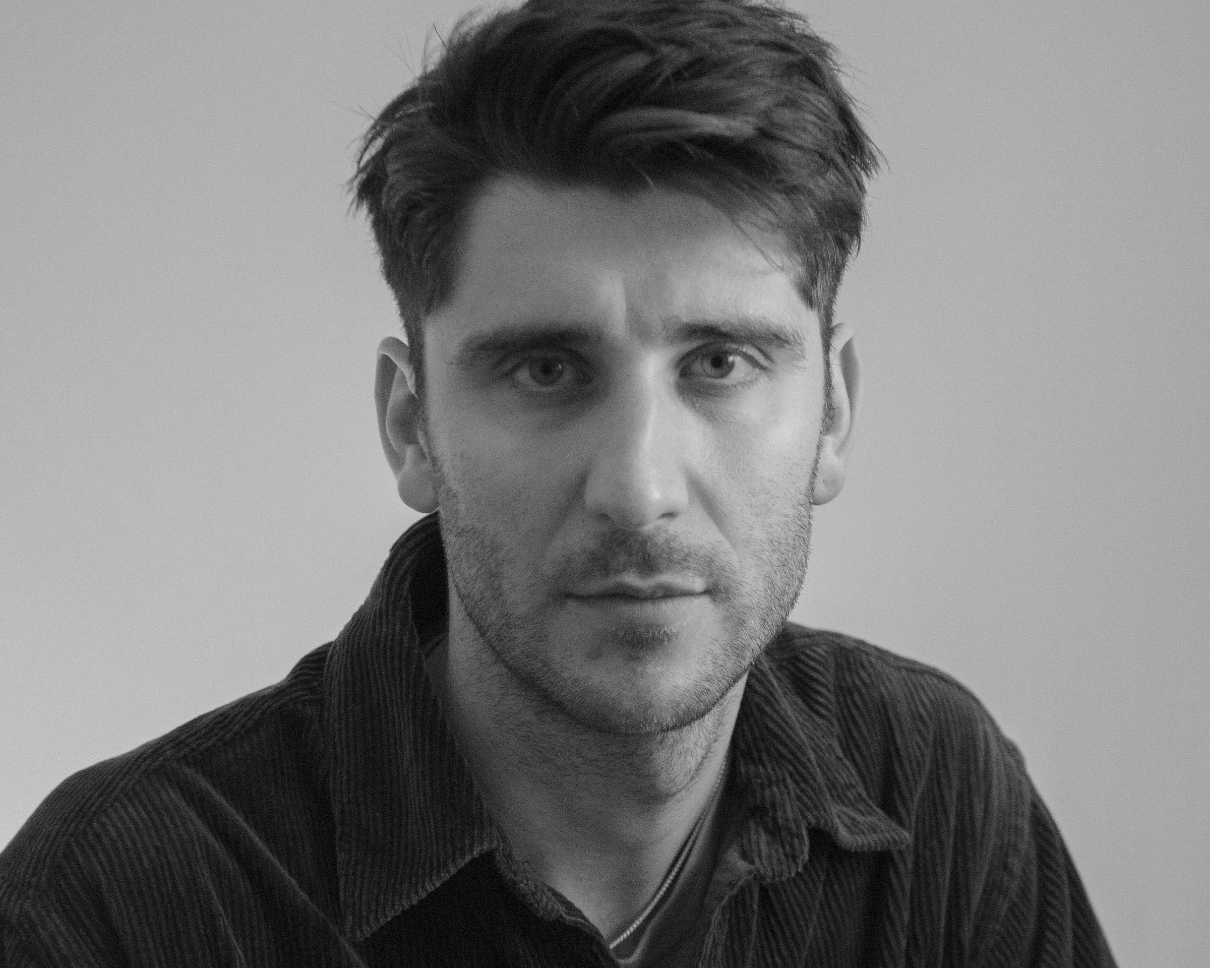 Black and white portrait of artist-in-residence Edoardo Mozzanega