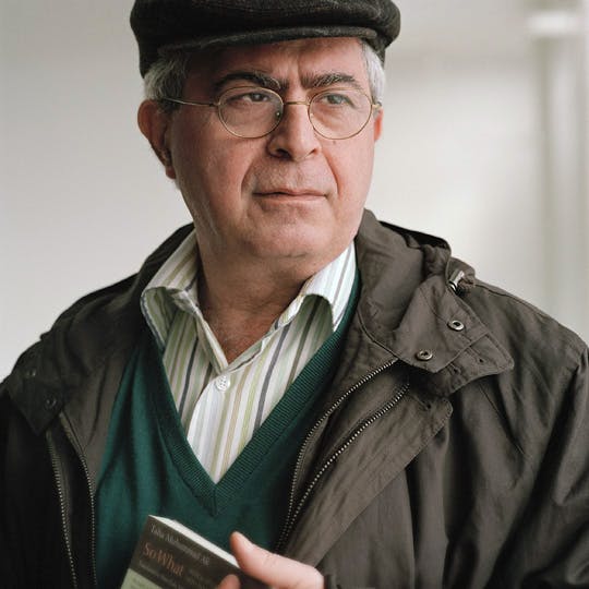 Photo of Elias Khoury, Lebanese writer, playwright, and literary critic. He looks serious toward his left. He is wearing glasses and has brown hair.