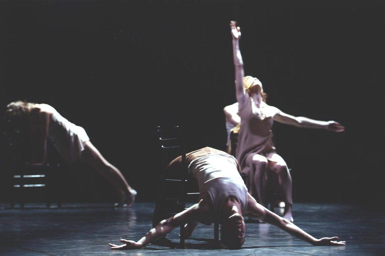 Three dancers, in different poses on three different chairs.