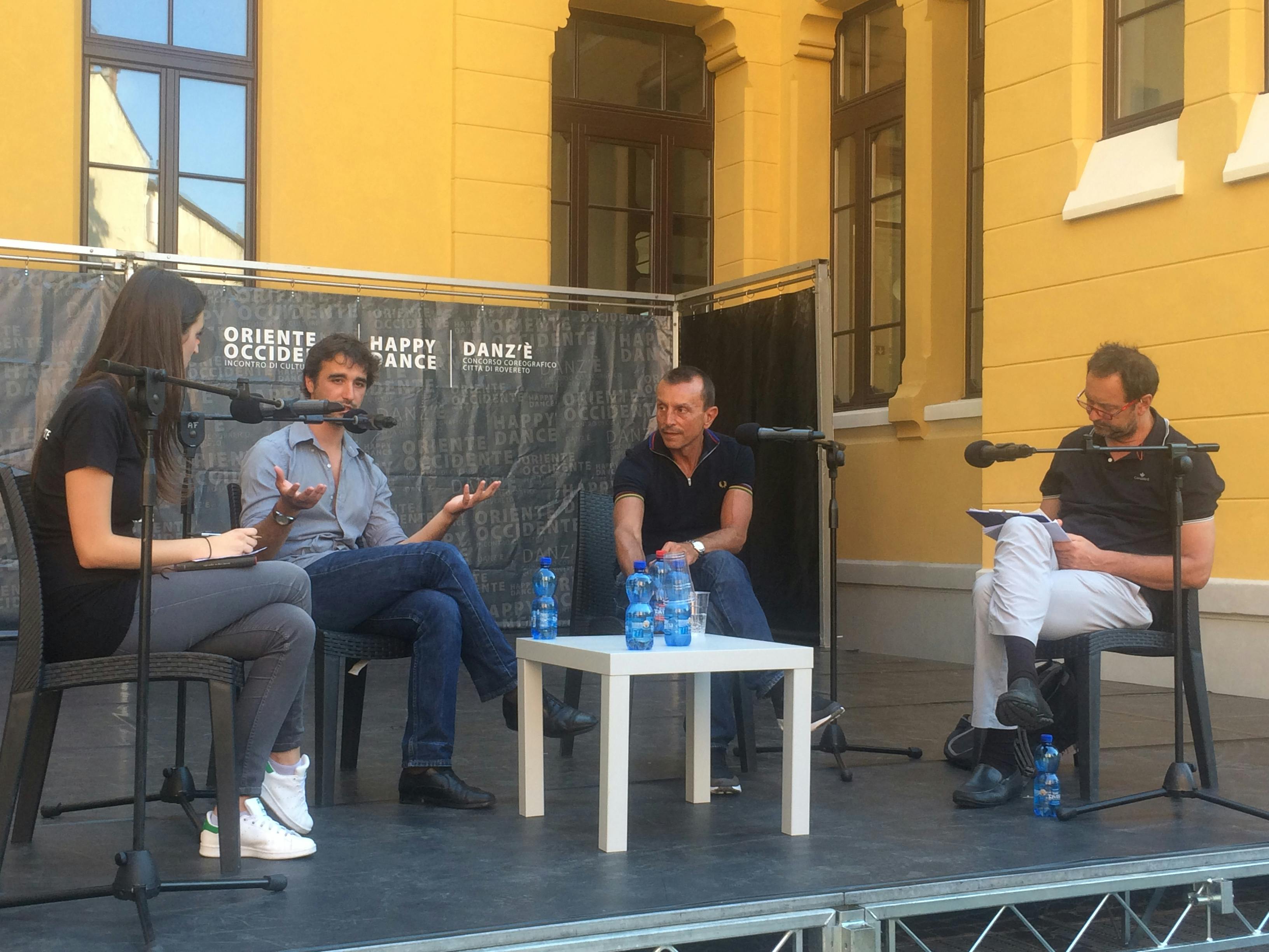 Robin Cristofari, Paco Dècina, Michele Lanziger, and a woman are seated on chairs on stage.