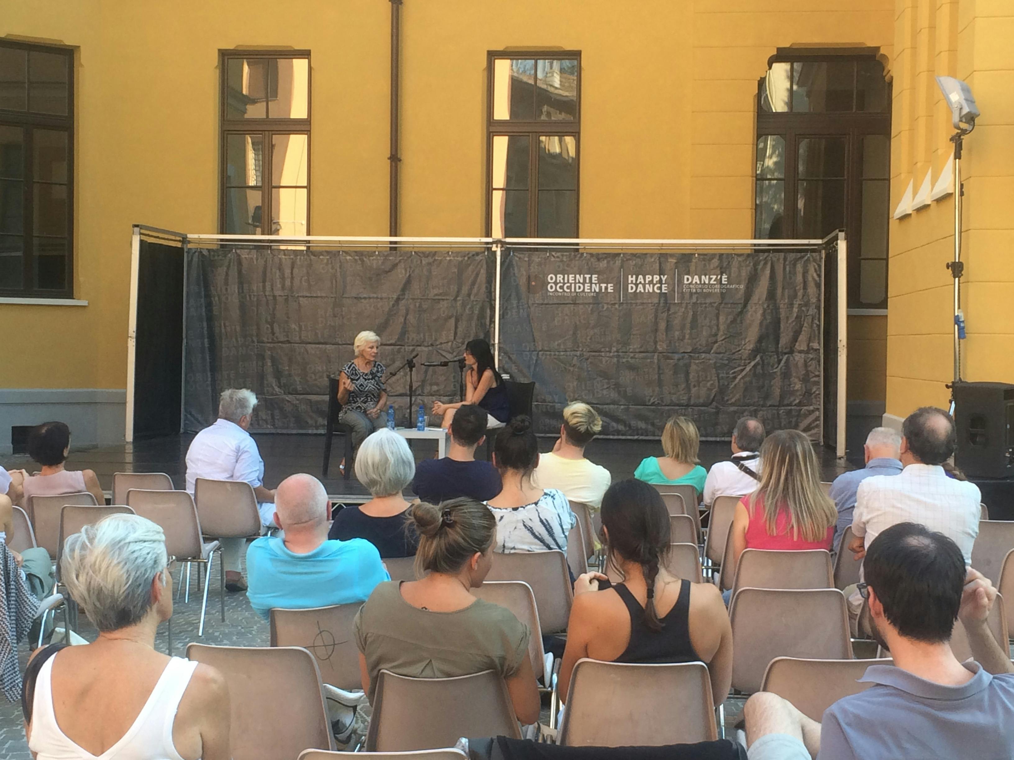 Elisa Guzzo Vaccarino, writer, and Katja Casagranda are speaking on stage while seated in front of an audience.