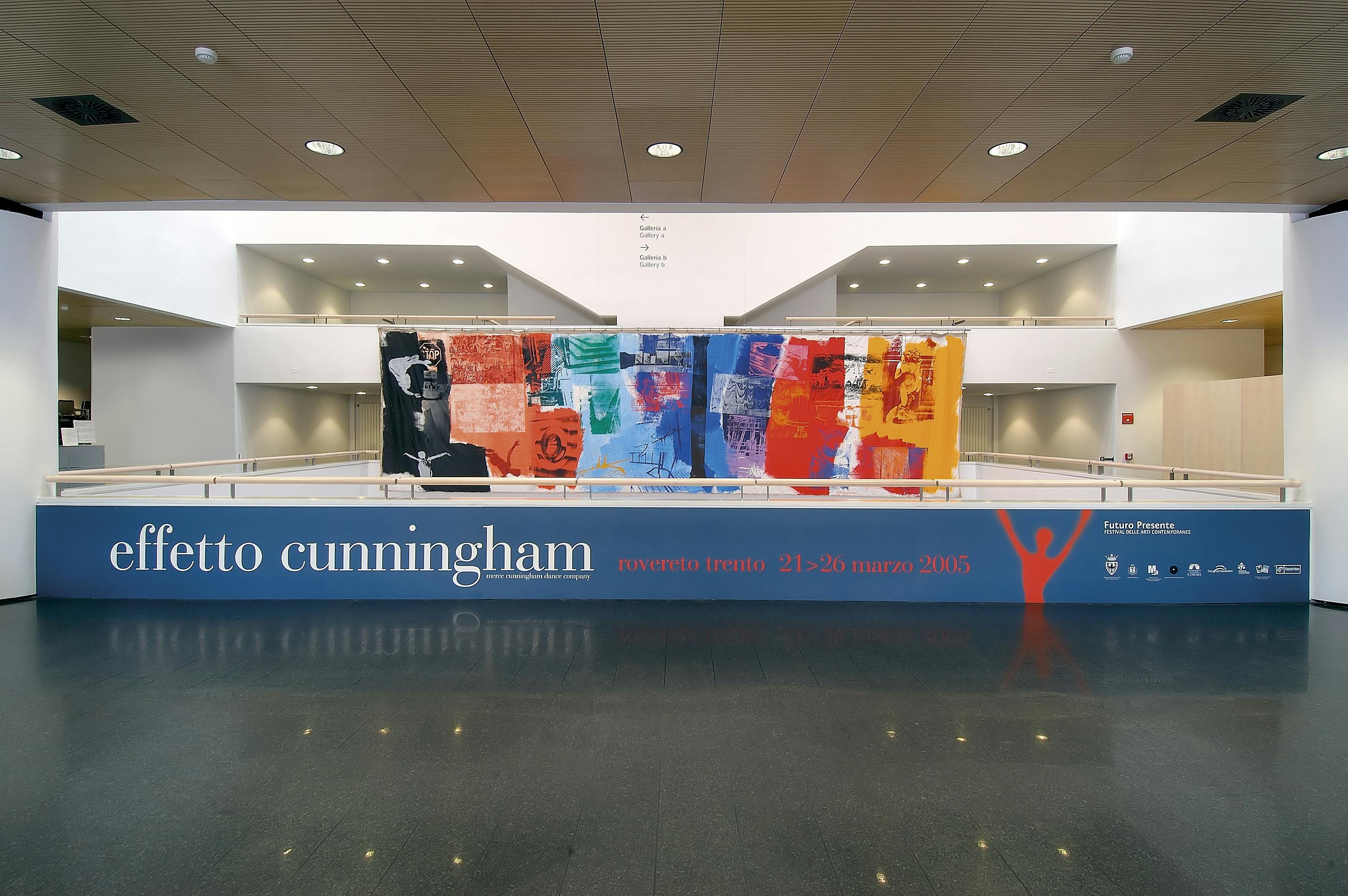 Foyer of the Mart museum, with a large horizontal banner of the Futuro Presente festival and Cunningham's work on display